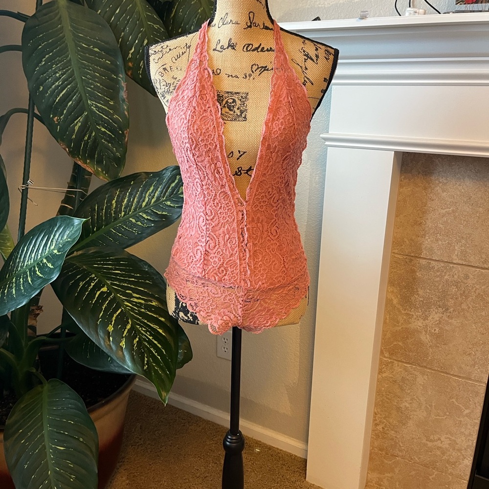 Haute Monde. Elegant coral lace bodysuit with a halter neckline.